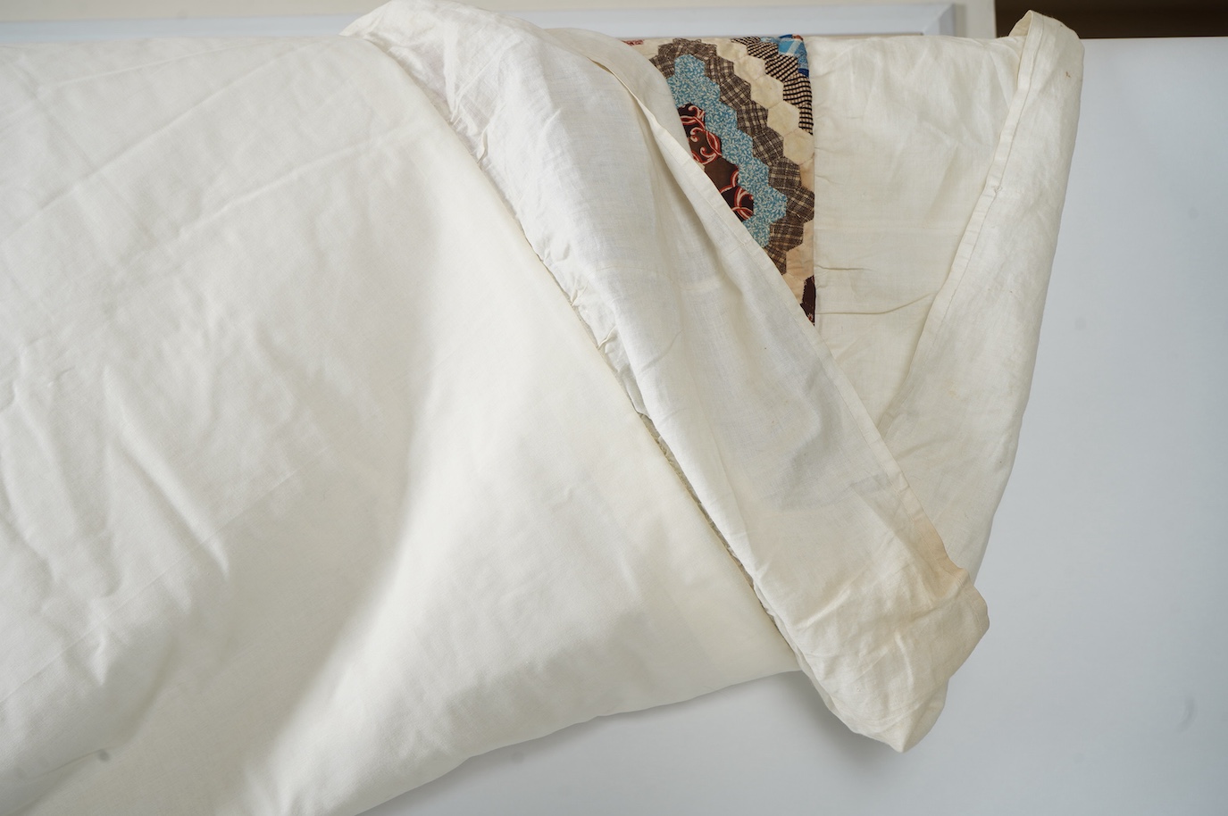 An ornate 19th century Log Cabin patchwork, made mostly from printed dress cottons from 1850-1900. 195cm long x 157cm wide., Condition - The colours are still bright and cotton strong. The patchwork backing and the cream